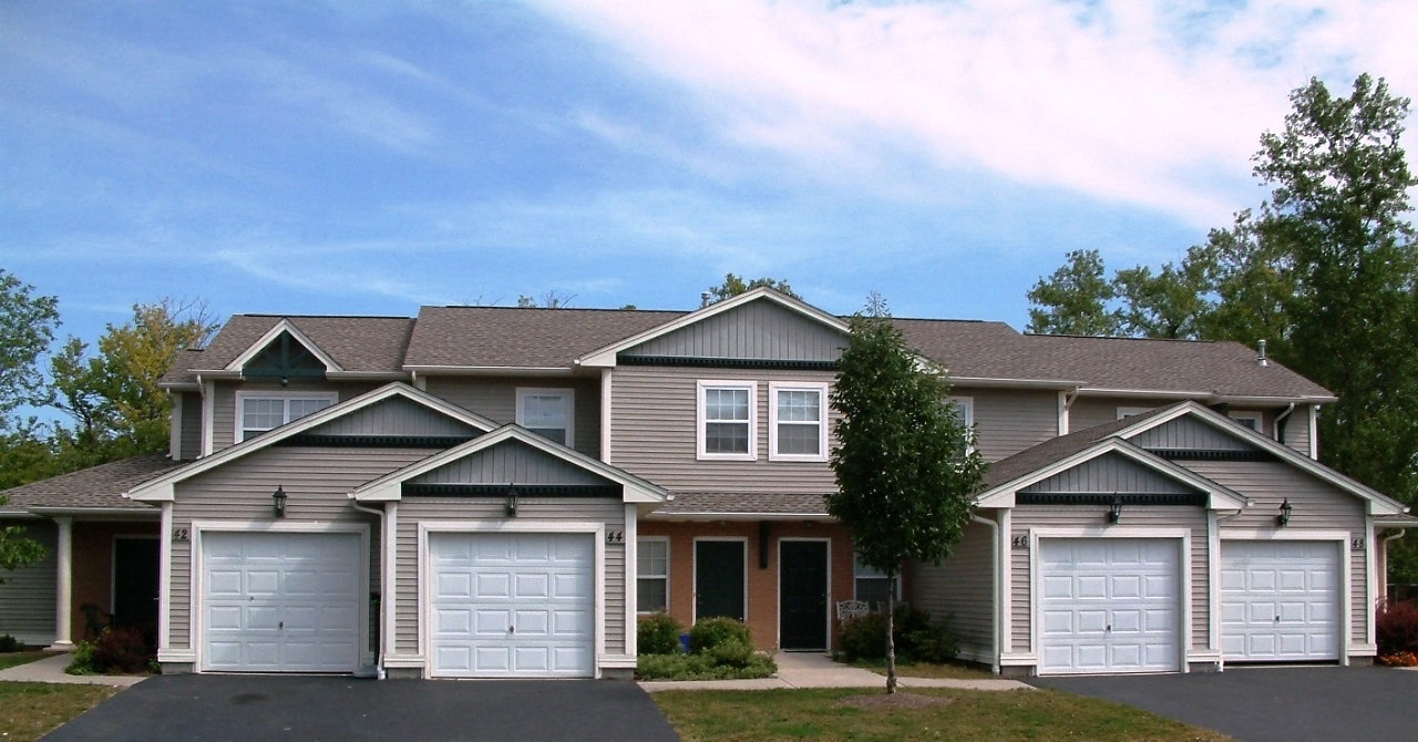 a house with two garage doors on a street